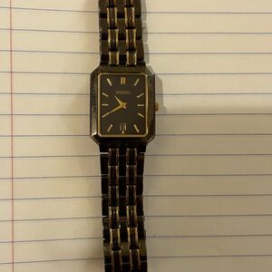 Women’s SEIKO watch in a black/charcoal with gold accents.